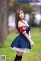 A woman in a blue dress is posing for a picture.
