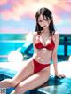 A woman in a red bikini sitting on the edge of a pool.