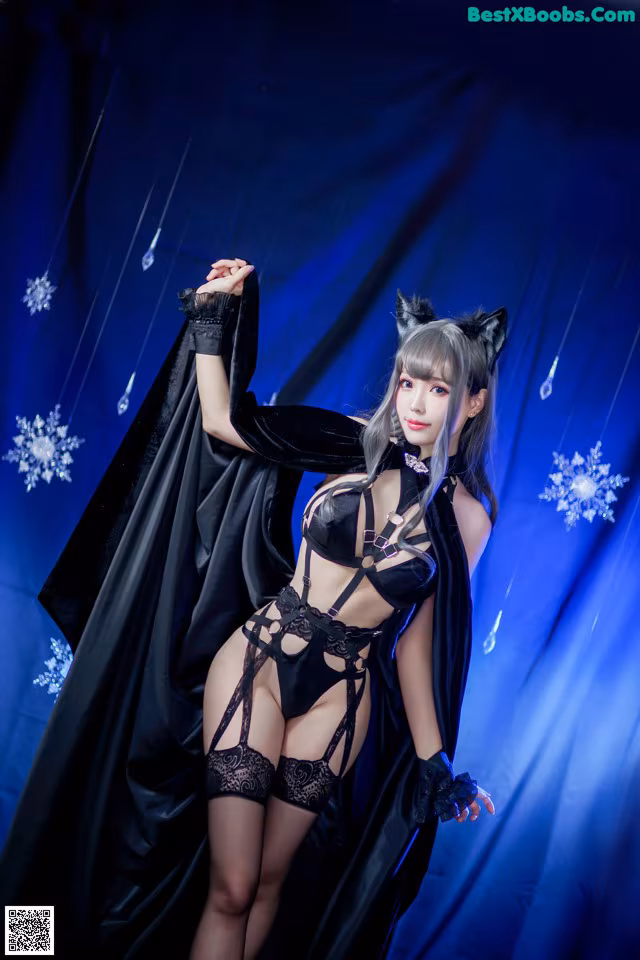 A woman dressed in a black cat costume posing for a picture.