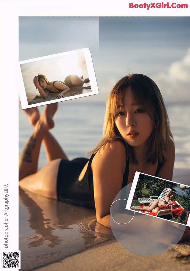 A woman in a black bathing suit laying on the beach.